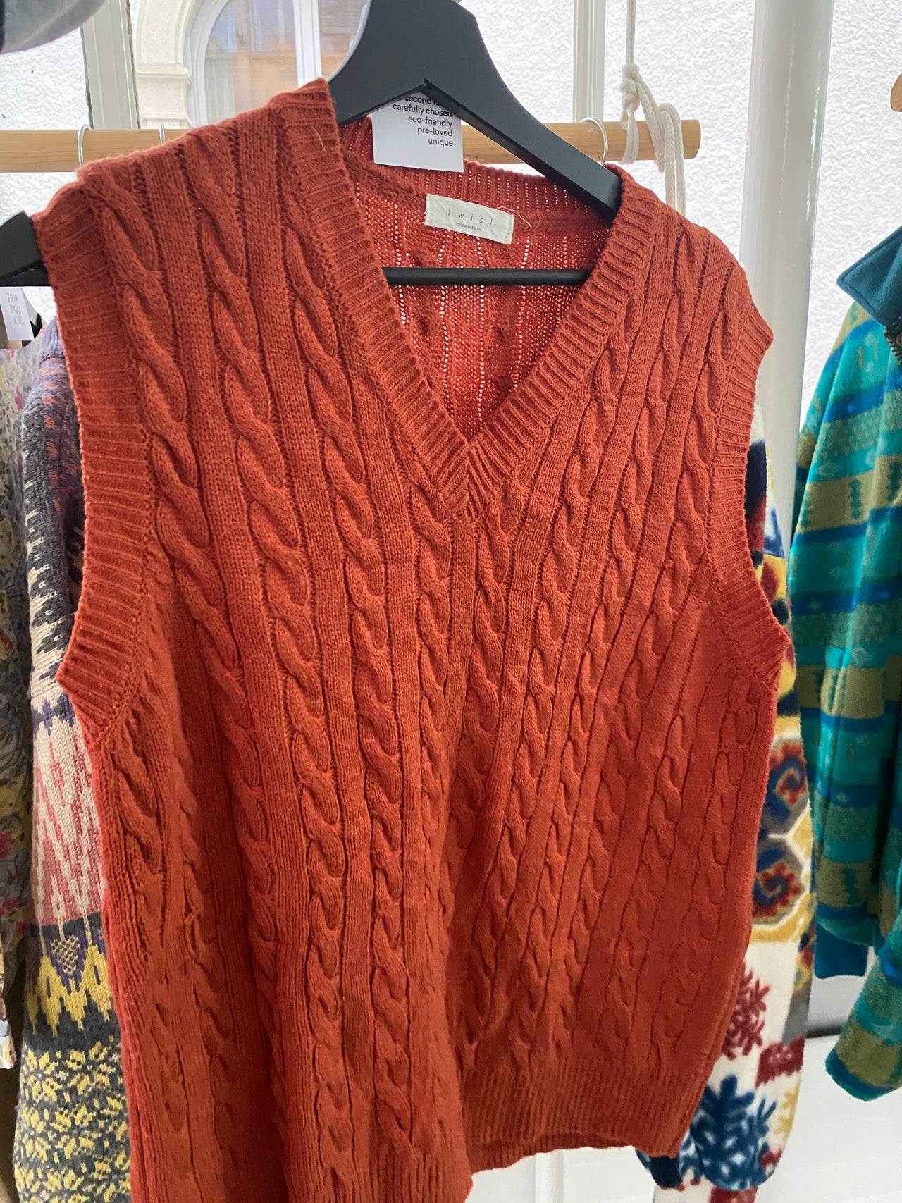 Black V-neck wool cardigan with pink/yellow pattern