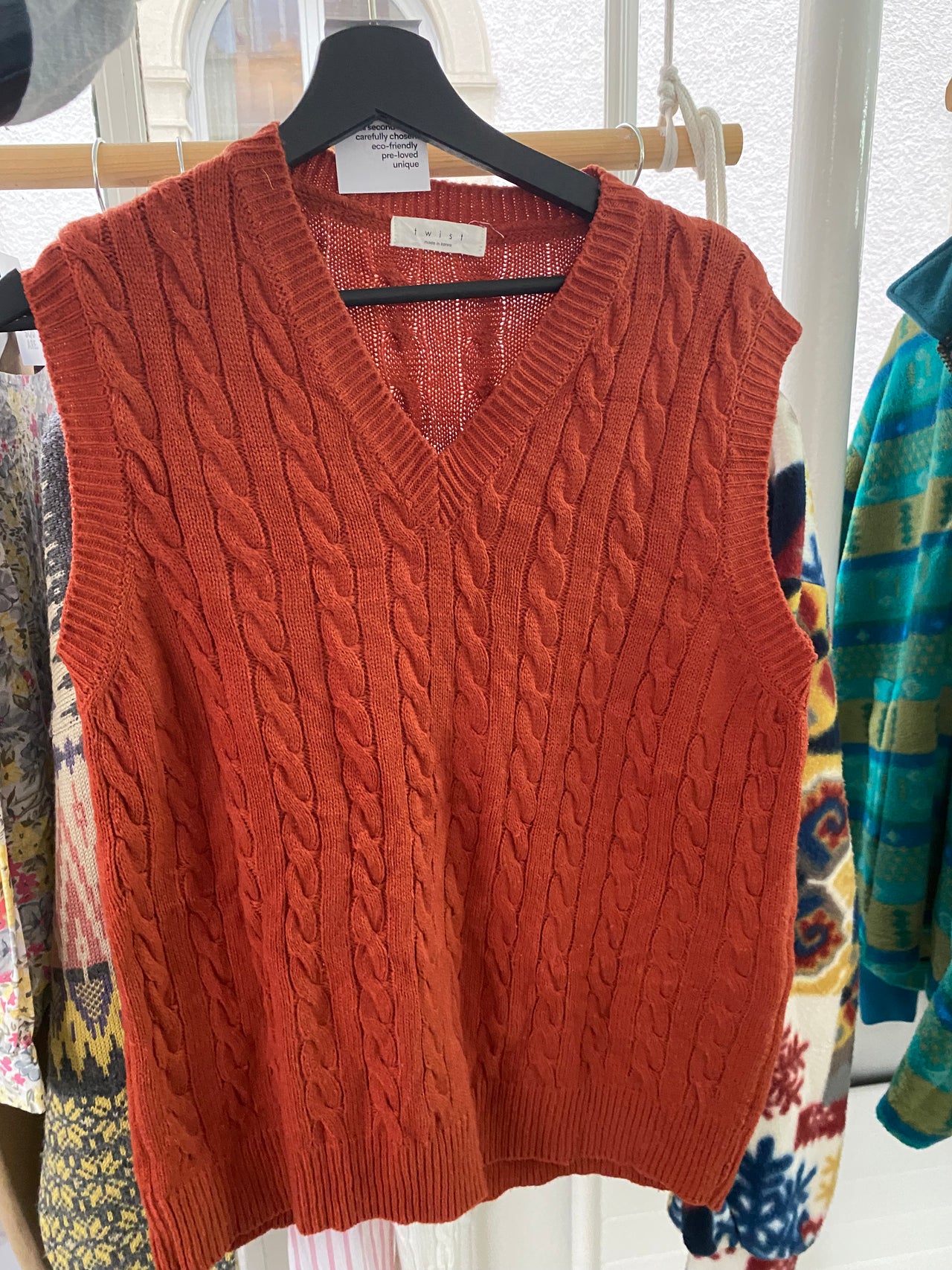 Black V-neck wool cardigan with pink/yellow pattern