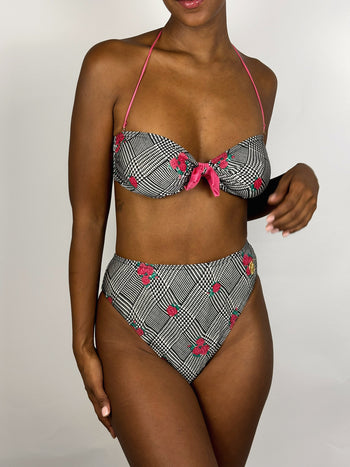 Black and white patterned two-piece swimsuit with pink flower