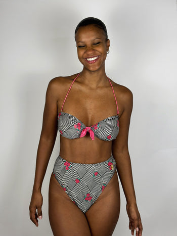 Black and white patterned two-piece swimsuit with pink flower