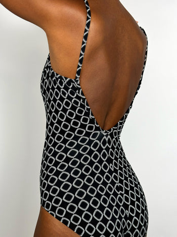 Black one-piece swimsuit with zipper and white pattern