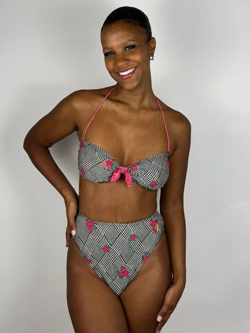 Black and white patterned two-piece swimsuit with pink flower