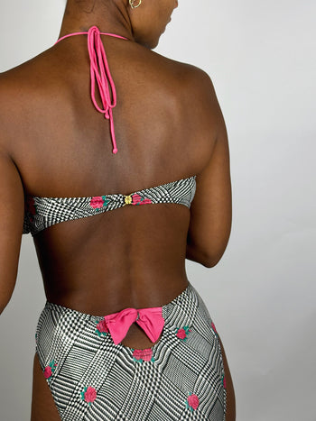 Black and white patterned two-piece swimsuit with pink flower