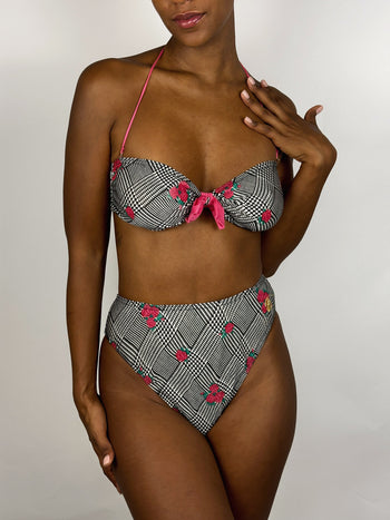 Black and white patterned two-piece swimsuit with pink flower