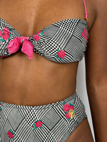 Black and white patterned two-piece swimsuit with pink flower