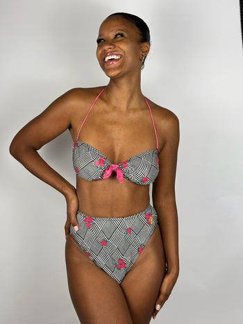 Black and white patterned two-piece swimsuit with pink flower