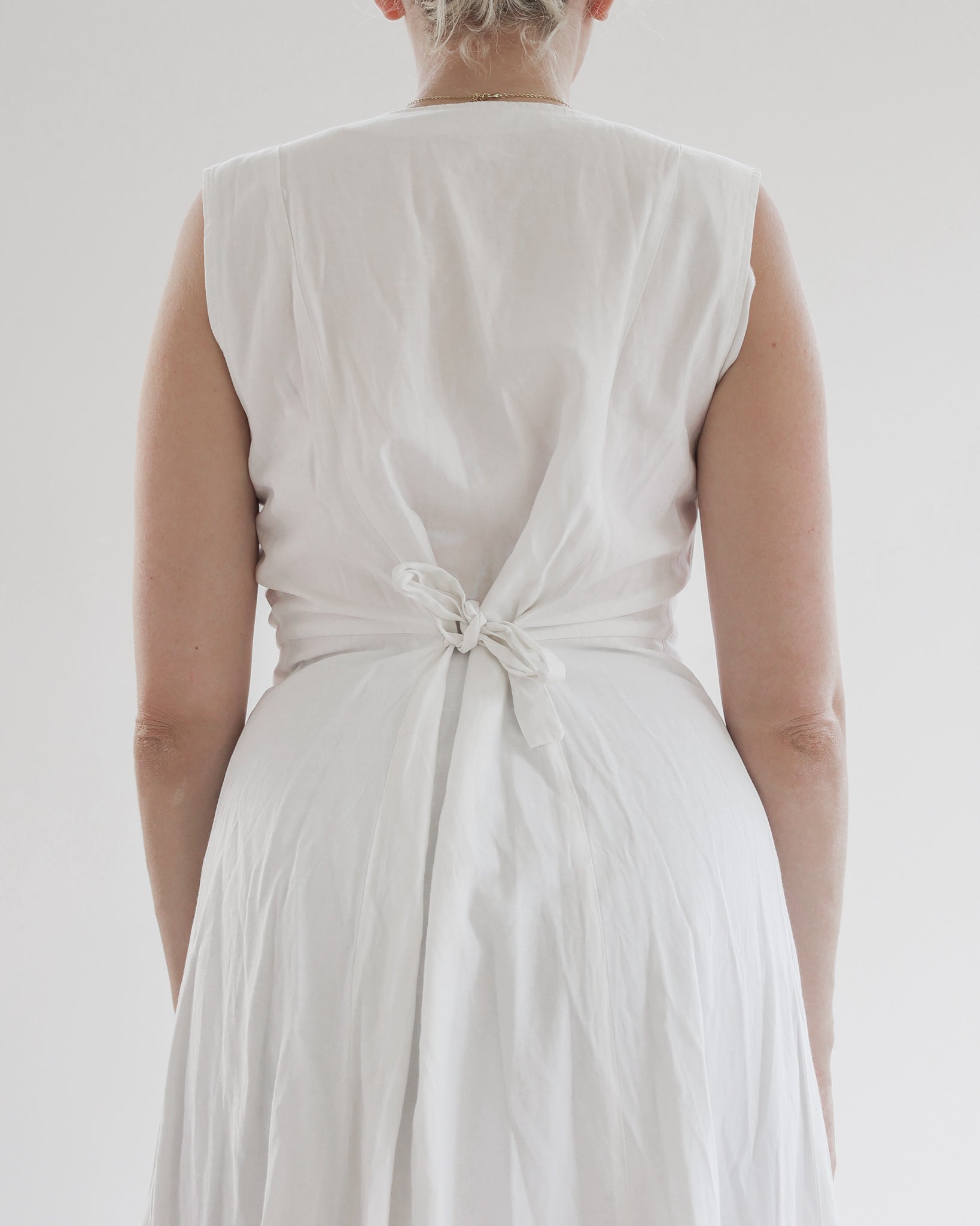 Robe blanche avec 4 boutons sur le décolleté